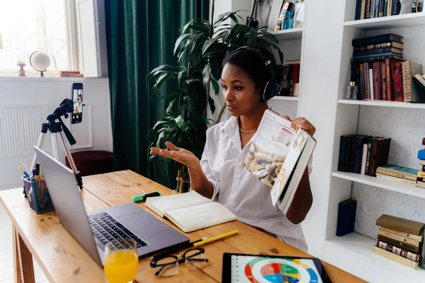A teacher sharing a lesson online from her desk