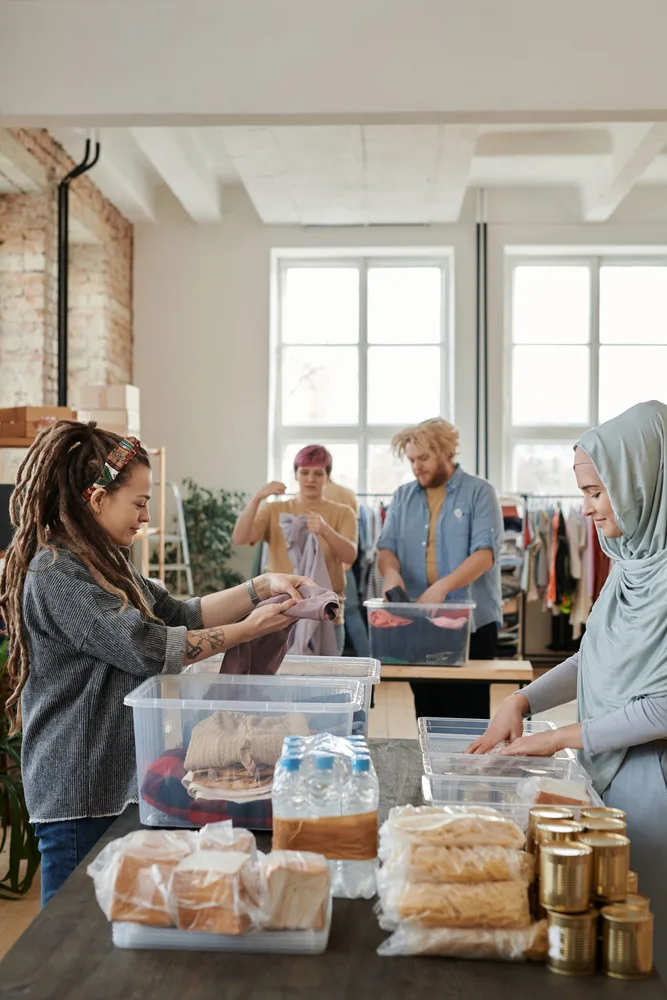 A group of volunteers sorting donated clothing together